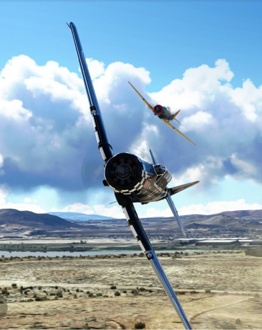Air racing aircraft banking over a desert landscape